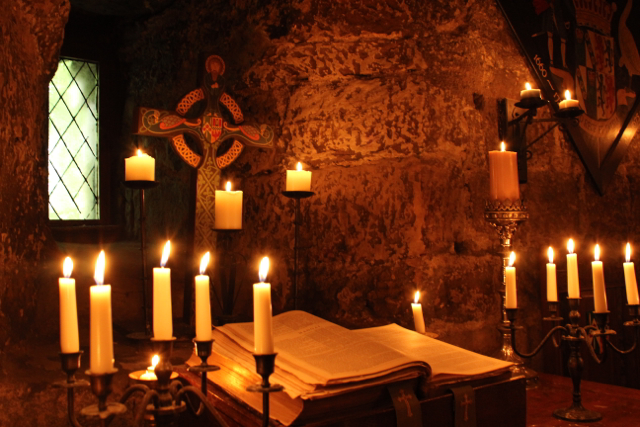 Candles flicker inside the ancient castle