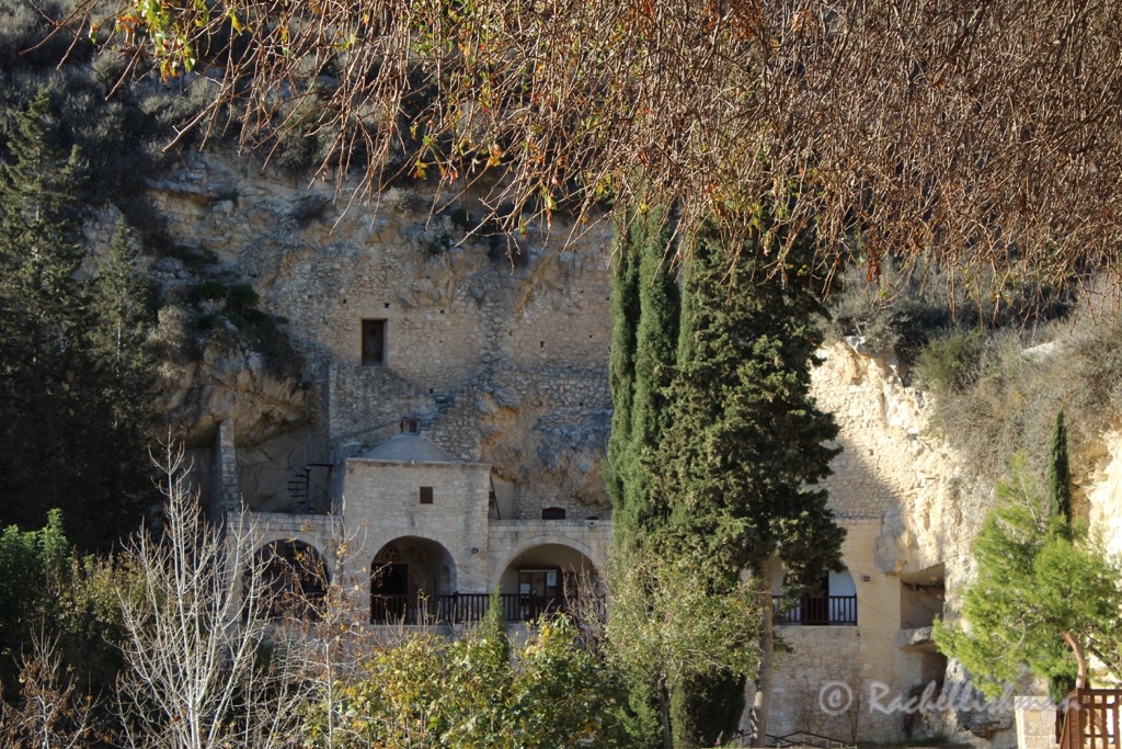 The monastery's original rooms are carved into the rock face beyond a sunny courtyard...
