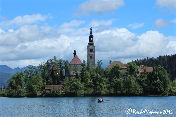 The post-card view that I couldn't resist. Tourists take a row boat over to Lake Bled's famous island church